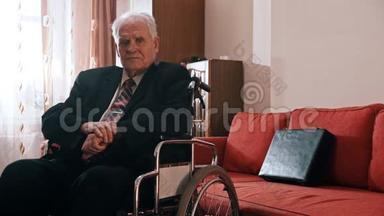 <strong>年迈</strong>的祖父-悲伤的祖父坐在轮椅上，看着摄像机